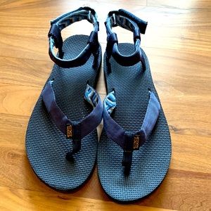 Teva flip flops size 10.  Navy blue straps with print on back side.
